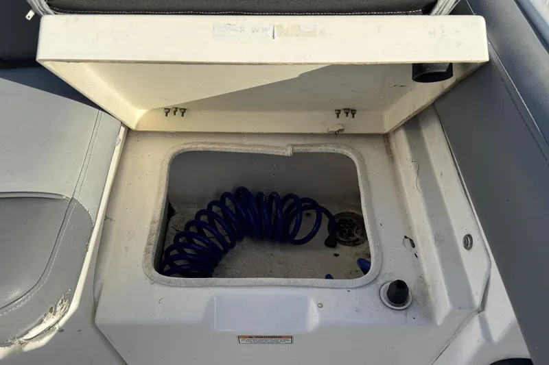 Slide: The Image of 2023 NauticStar 242L Offshore boat helm with steering wheel and control panel. - 18