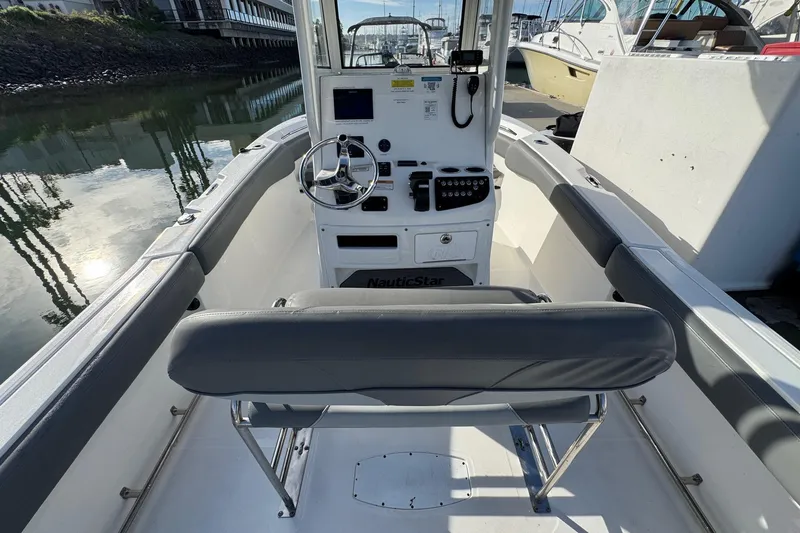 Slide: The Image of Control panel of 2023 NauticStar 242L Offshore boat with warning labels and Lenco trim tab switches. - 19