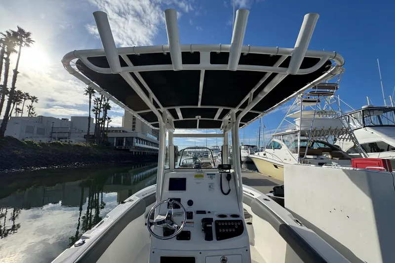 Slide: The Image of 2023 NauticStar 242L Offshore dashboard with Simrad display and safety notices. - 20