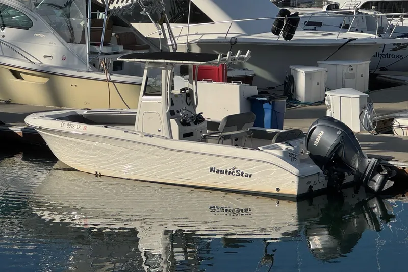 Slide: The Image of 2023 NauticStar 242L Offshore boat control panel with windlass switch and battery. - 4