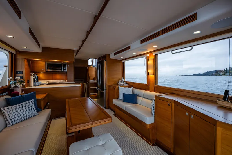 Slide: The Image of Luxurious interior of 2026 Fleming 55 Pilothouse yacht with ocean view and elegant furnishings. - 22