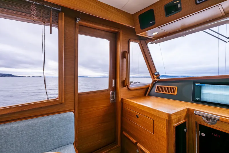Slide: The Image of Interior of 2026 Fleming 55 Pilothouse yacht with wooden finish and ocean view. - 38