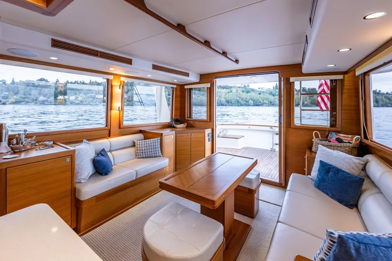 Slide: The Image of Luxurious interior of 2026 Fleming 55 Pilothouse yacht with elegant seating and scenic water views. - 18