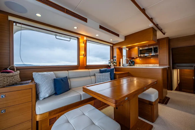 Slide: The Image of Luxurious interior of 2026 Fleming 55 Pilothouse yacht with modern kitchen and seating area. - 19