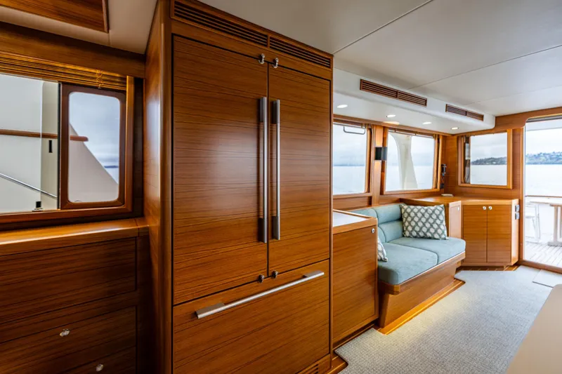 Slide: The Image of Luxurious 2026 Fleming 55 Pilothouse interior with elegant wood finish and cozy seating area. - 24