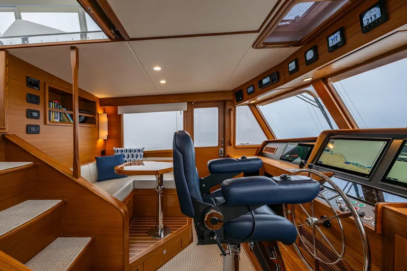 Slide: The Image of Pilothouse interior of 2026 Fleming 55, featuring navigation equipment and seating area. - 33