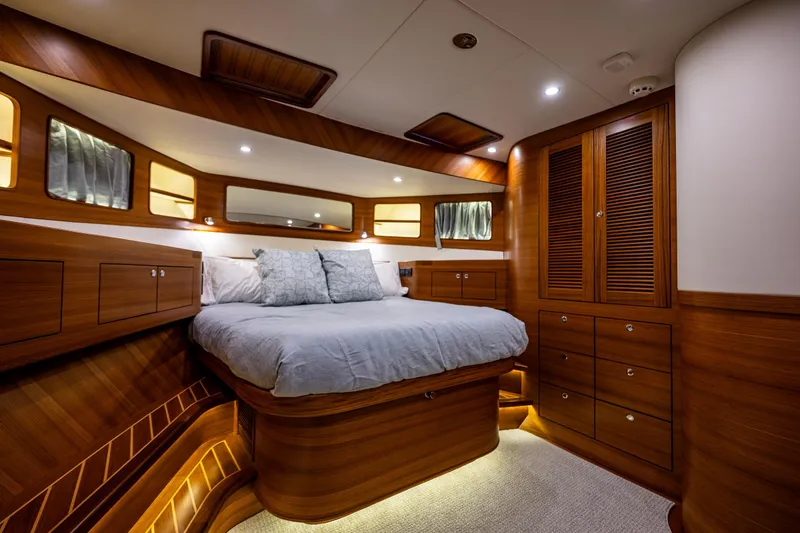Slide: The Image of Luxurious cabin interior of 2026 Fleming 55 Pilothouse yacht with wood finish and cozy bed. - 61