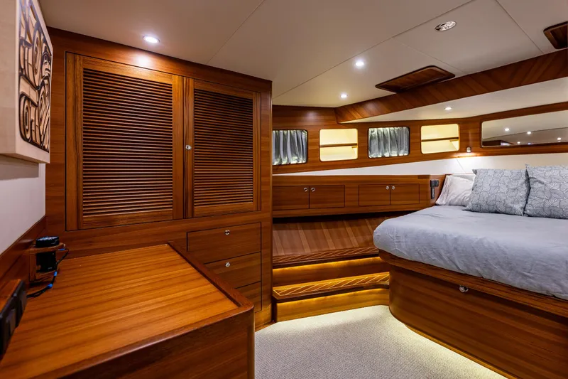 Slide: The Image of Luxurious 2026 Fleming 55 Pilothouse cabin with elegant wood finishes and ambient lighting. - 63