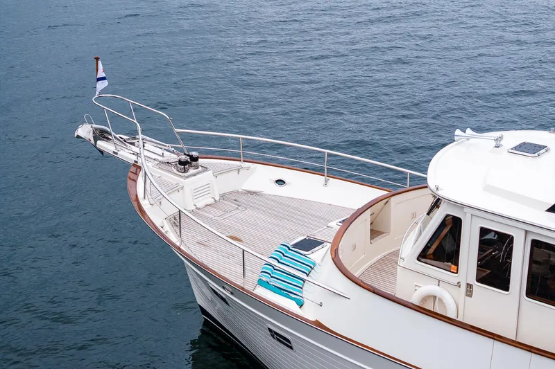 Slide: The Image of 2026 Fleming 55 Pilothouse yacht on calm water, featuring a sleek deck and pilothouse. - 15