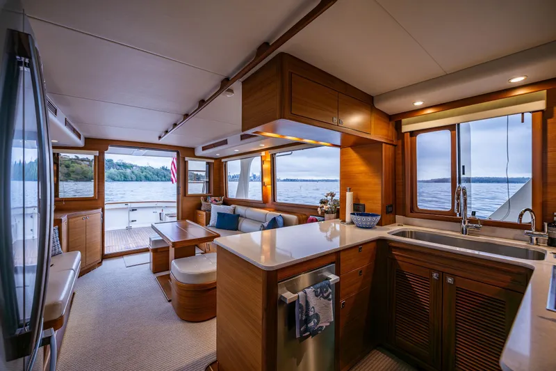 Slide: The Image of Luxurious interior of 2026 Fleming 55 Pilothouse yacht with modern kitchen and scenic views. - 26