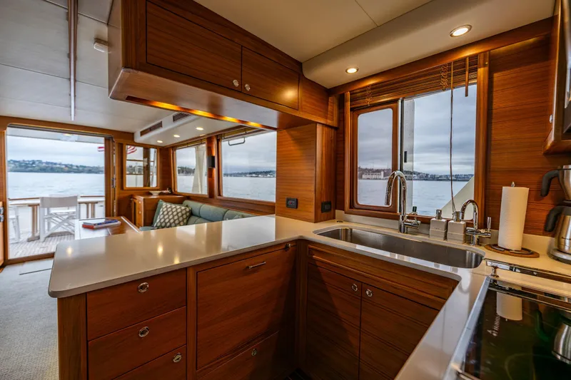 Slide: The Image of Luxurious 2026 Fleming 55 Pilothouse yacht interior with modern kitchen and scenic water views. - 27
