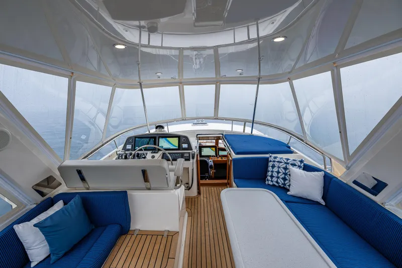 Slide: The Image of Luxurious interior of 2026 Fleming 55 Pilothouse yacht with blue seating and navigation controls. - 37