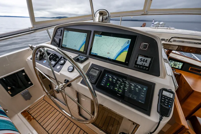Slide: The Image of Pilothouse of 2026 Fleming 55 yacht with advanced navigation systems and steering wheel. - 39