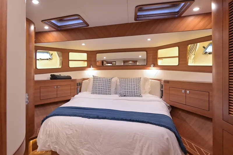 Slide: The Image of Luxurious bedroom in a 2027 Fleming 55 Pilothouse yacht. - 48