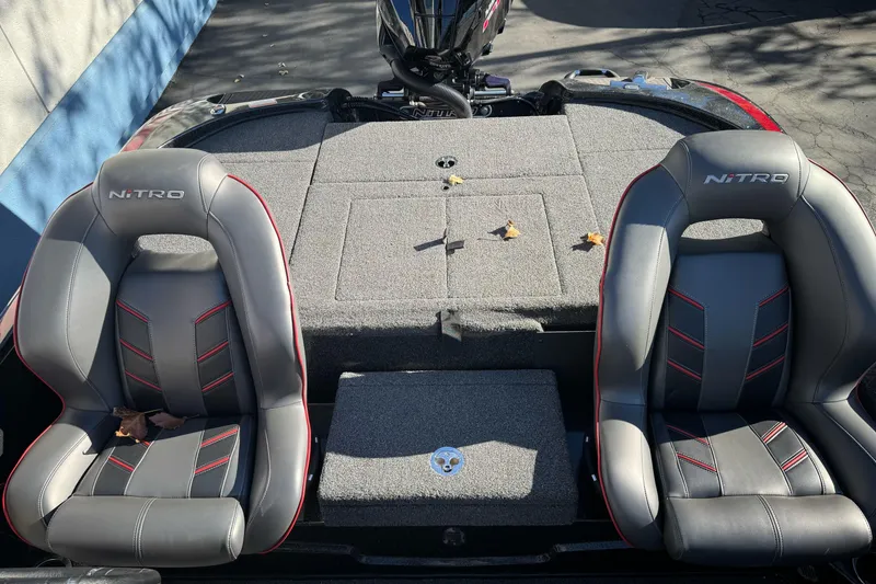 Slide: The Image of 2023 Nitro Z18 boat interior with two gray and red seats. - 16