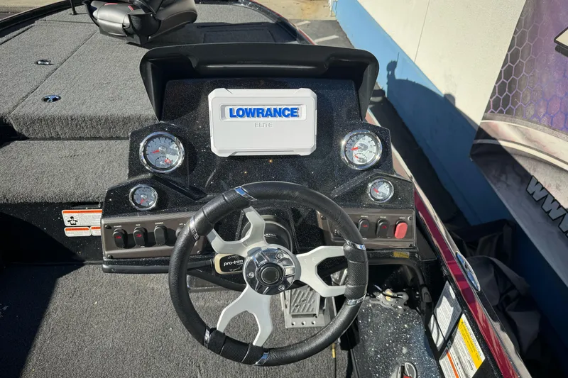 Slide: The Image of 2023 Nitro Z18 boat dashboard with Lowrance Elite display and steering wheel. - 17