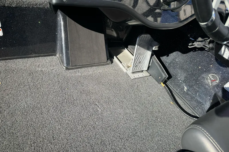 Slide: The Image of 2023 Nitro Z18 boat interior with pedal and carpeted flooring. - 18