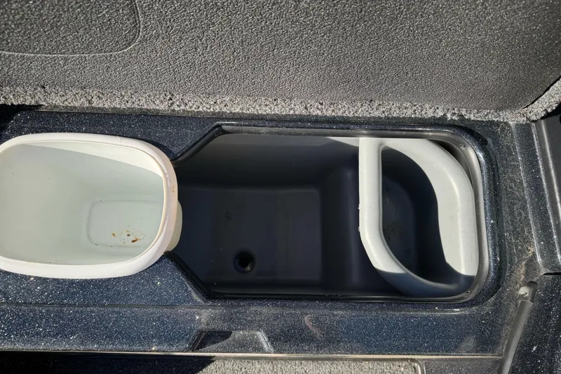 Slide: The Image of Interior storage compartment of 2023 Nitro Z18 boat, featuring cup holders and storage space. - 19