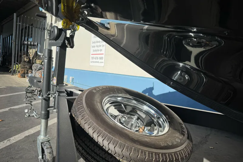 Slide: The Image of Trailer hitch and spare tire of 2023 Nitro Z18 boat in parking lot. - 3
