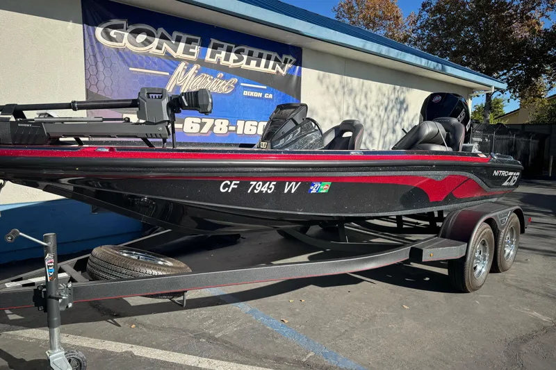Slide: The Image of 2023 Nitro Z18 boat on trailer at dealership, featuring sleek black and red design. - 7