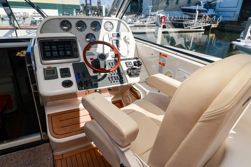 Slide: The Image of Helm of 2004 Chris-Craft Roamer 40 yacht with leather seat and modern controls. - 13