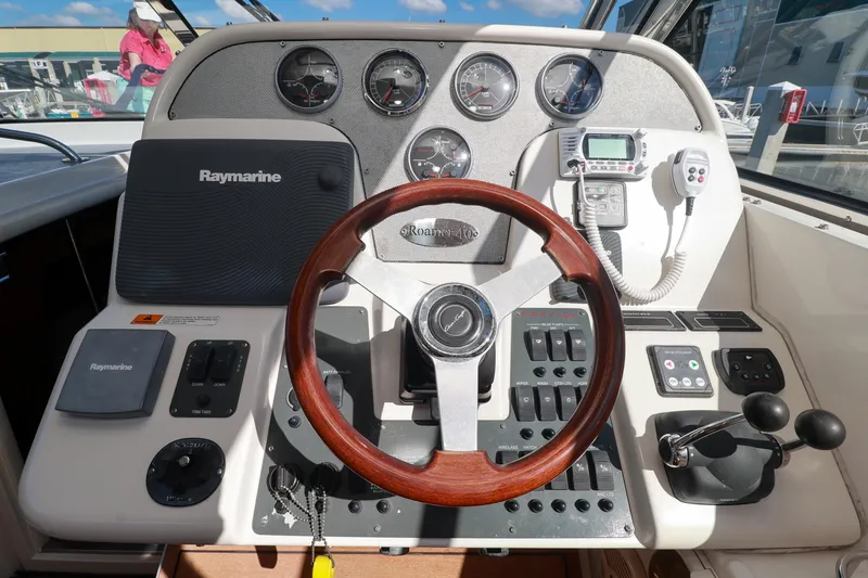 Slide: The Image of Control panel of 2004 Chris-Craft Roamer 40 with Raymarine navigation system and wooden steering wheel. - 15