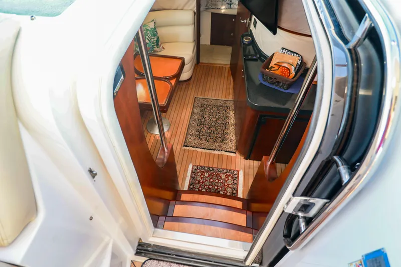 Slide: The Image of Interior view of 2004 Chris-Craft Roamer 40 yacht, featuring elegant wood flooring and cozy seating. - 18