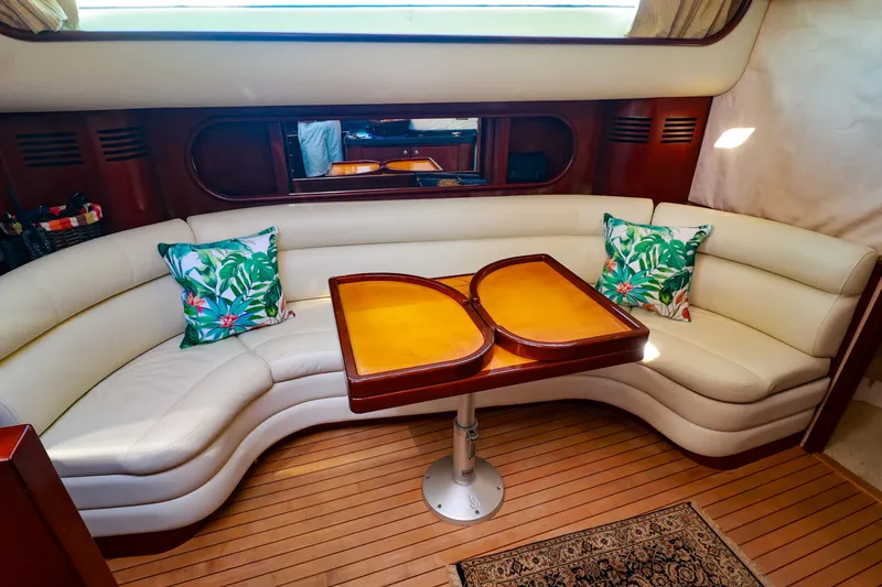 Slide: The Image of Luxurious interior of 2004 Chris-Craft Roamer 40 yacht with curved seating and tropical cushions. - 32
