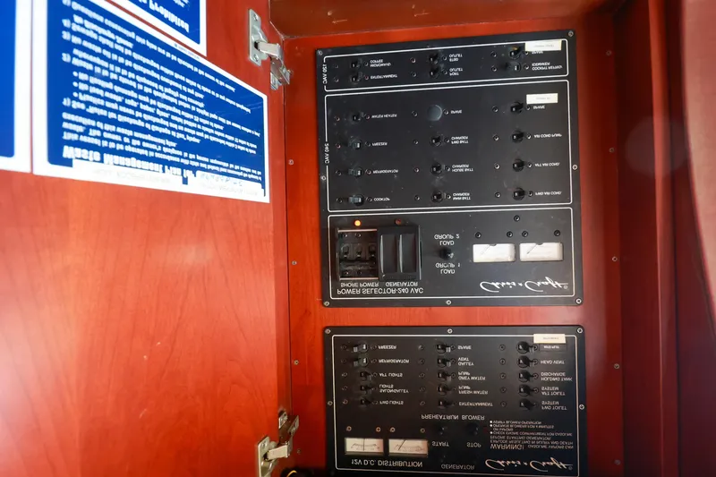 Slide: The Image of Electrical panel inside 2004 Chris-Craft Roamer 40 yacht, featuring control switches and circuit breakers. - 35