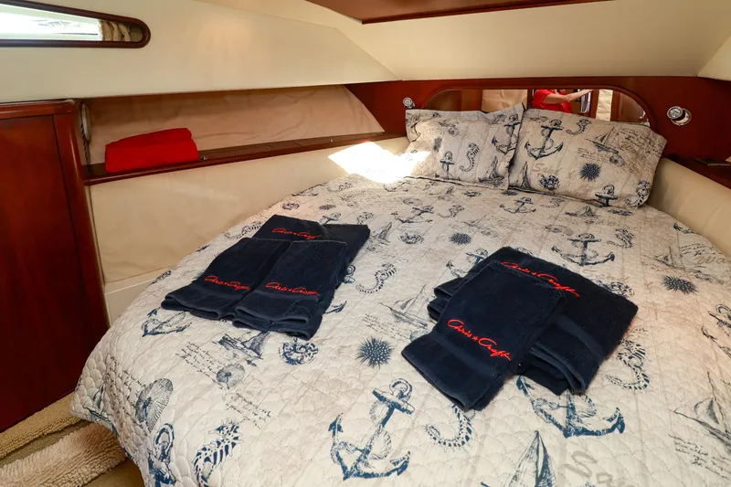 Slide: The Image of Luxurious cabin interior of 2004 Chris-Craft Roamer 40 with nautical-themed bedding and towels. - 36