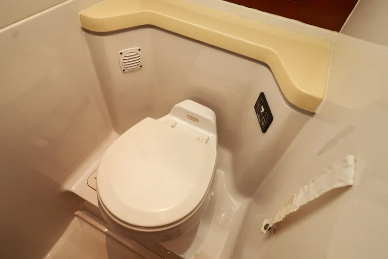 Slide: The Image of 2004 Chris-Craft Roamer 40 yacht bathroom with modern toilet and beige countertop. - 43