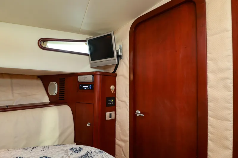 Slide: The Image of Interior cabin of 2004 Chris-Craft Roamer 40 with wood paneling and mounted TV. - 44