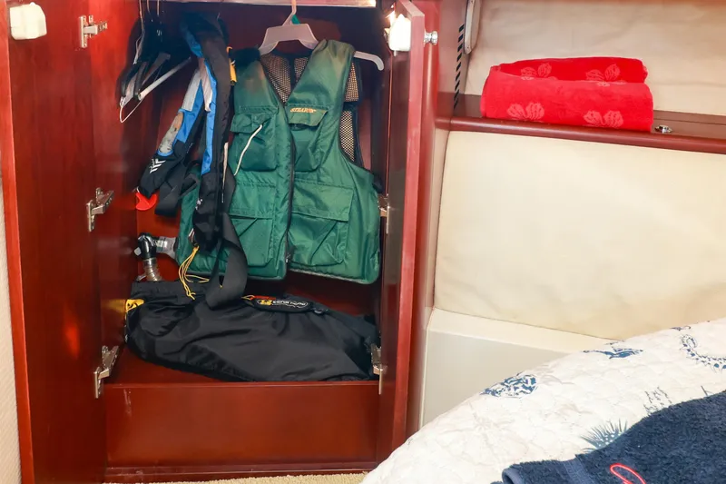 Slide: The Image of Closet in 2004 Chris-Craft Roamer 40 with life jackets and red towels. - 45