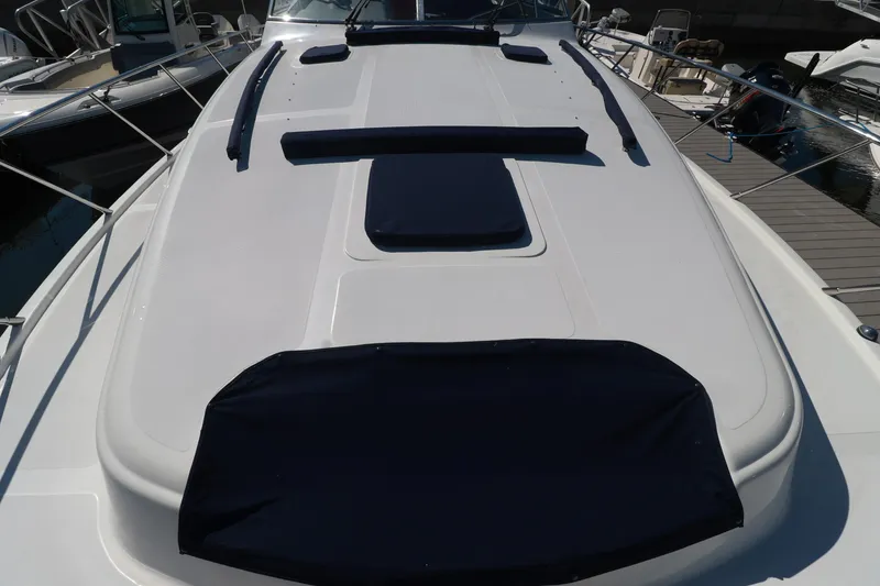 Slide: The Image of 2004 Chris-Craft Roamer 40 yacht deck with navy cushions at marina. - 47