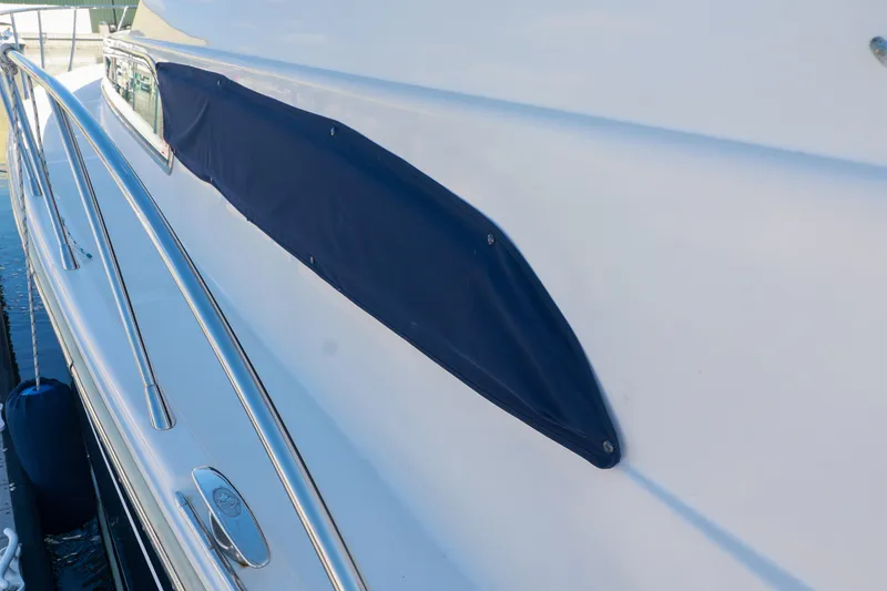 Slide: The Image of 2004 Chris-Craft Roamer 40 yacht with sleek design and blue cover detail. - 49