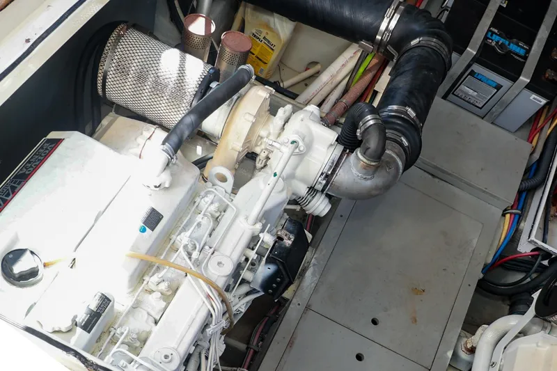 Slide: The Image of Engine compartment of 2004 Chris-Craft Roamer 40, showcasing mechanical components and wiring. - 52