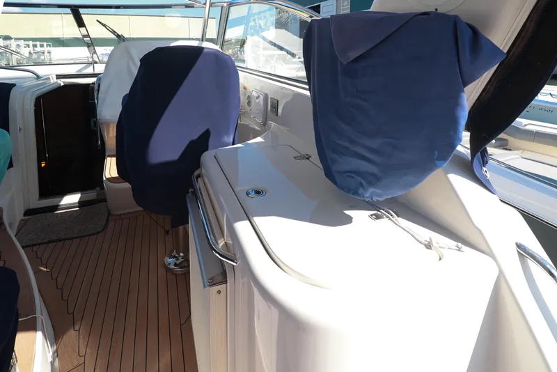 Slide: The Image of 2004 Chris-Craft Roamer 40 yacht interior with covered seats and wooden flooring. - 60