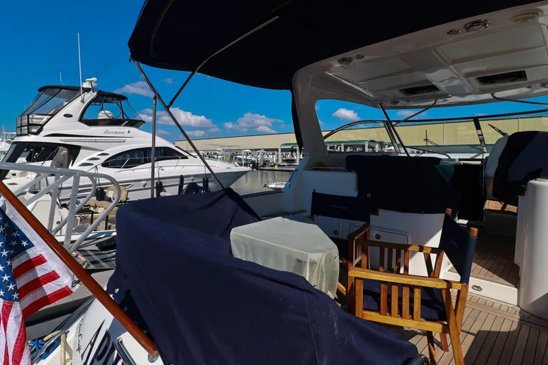 Slide: The Image of 2004 Chris-Craft Roamer 40 yacht interior with seating, docked at marina. - 61