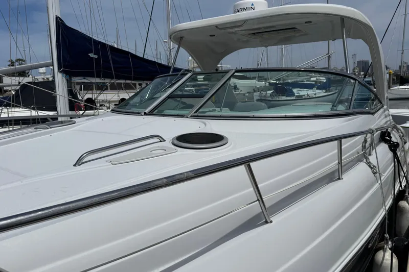 Slide: The Image of 2008 Crownline 340 CR boat docked at marina, showcasing sleek design and modern features. - 5