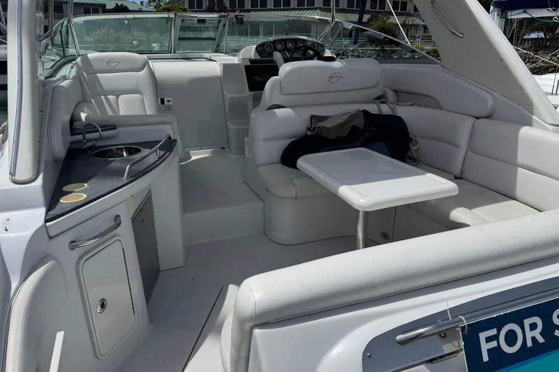 Slide: The Image of 2008 Crownline 340 CR boat interior with seating, table, and kitchenette. - 8