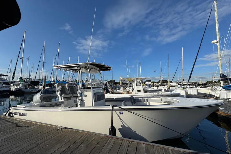 Slide: The Image of 2025 Defiance Catalina 240 boat docked at a marina under a clear blue sky. - 11