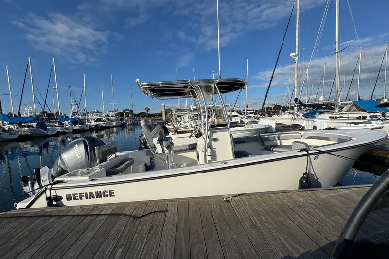 Slide: The Image of 2025 Defiance Catalina 240 boat docked at marina, clear sky, calm water. - 12