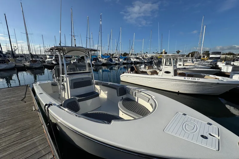 Slide: The Image of 2025 Defiance Catalina 240 boat docked in a marina with sailboats in the background. - 13