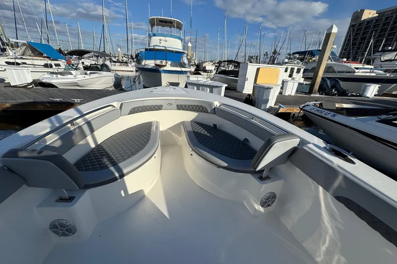 Slide: The Image of 2025 Defiance Catalina 240 boat docked at marina under blue sky. - 14
