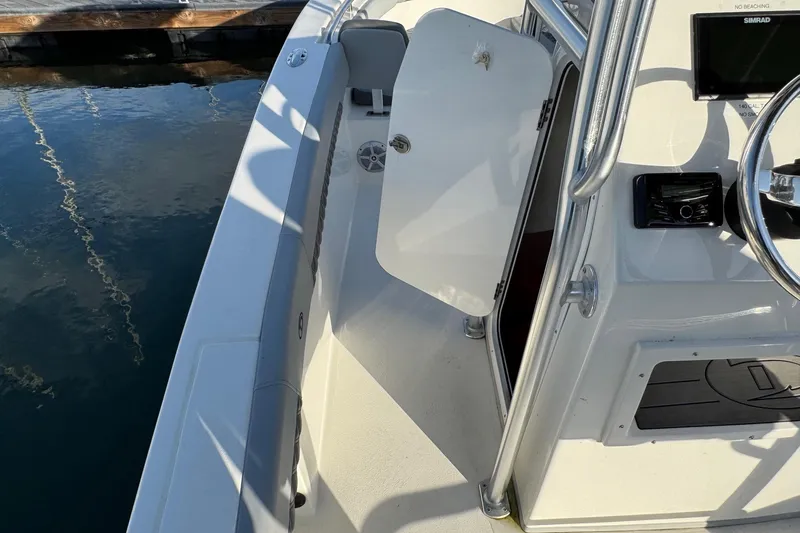 Slide: The Image of 2025 Defiance Catalina 240 boat interior with open cabin door and steering console. - 20