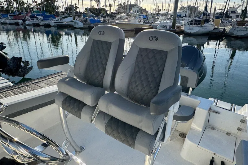 Slide: The Image of Luxury seating on 2025 Defiance Catalina 240 boat, docked at marina with sailboats. - 23