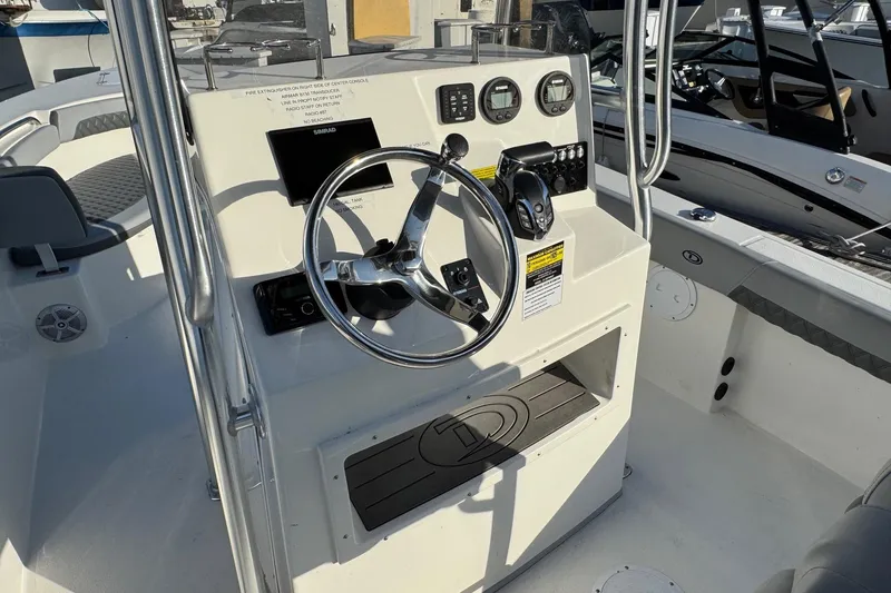 Slide: The Image of 2025 Defiance Catalina 240 boat cockpit with steering wheel and control panel. - 26