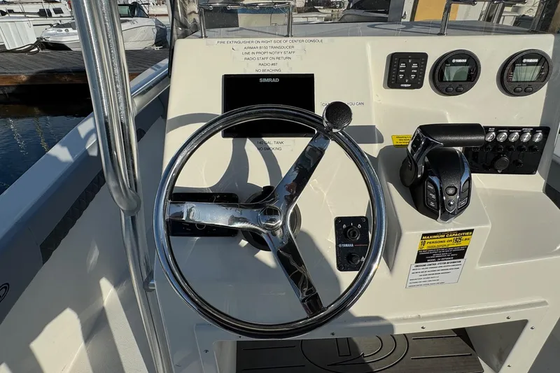 Slide: The Image of Steering console of 2025 Defiance Catalina 240 boat with controls and gauges. - 29
