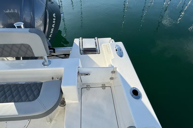 Slide: The Image of 2025 Defiance Catalina 240 boat stern with Yamaha engine, docked on calm water. - 34