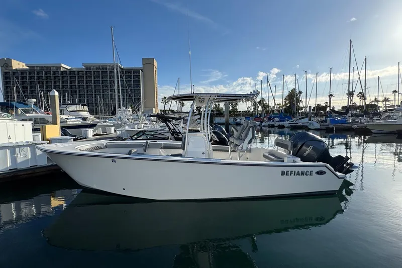 Slide: The Image of 2025 Defiance Catalina 240 boat docked in marina, clear sky, calm water. - 5